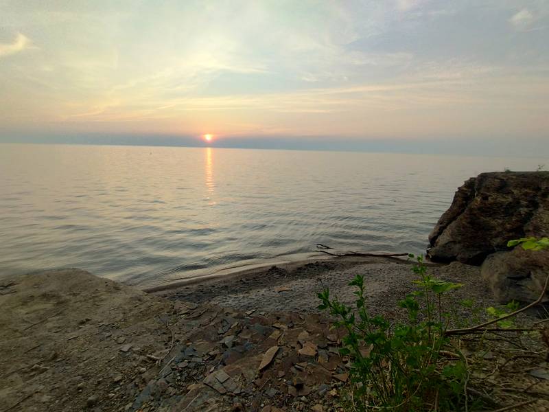 Sunset over water from on a cliff